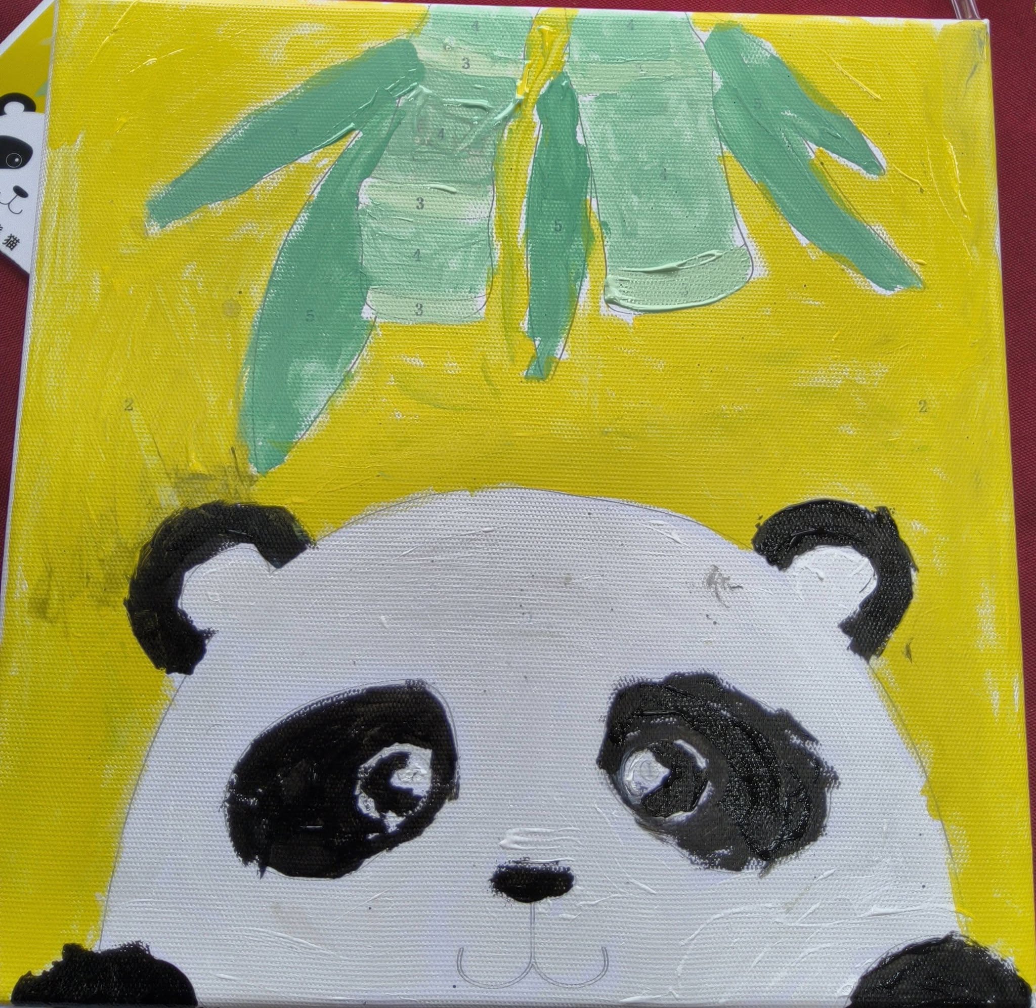 Child's panda painting with bamboo leaves on yellow background from Play & Unite