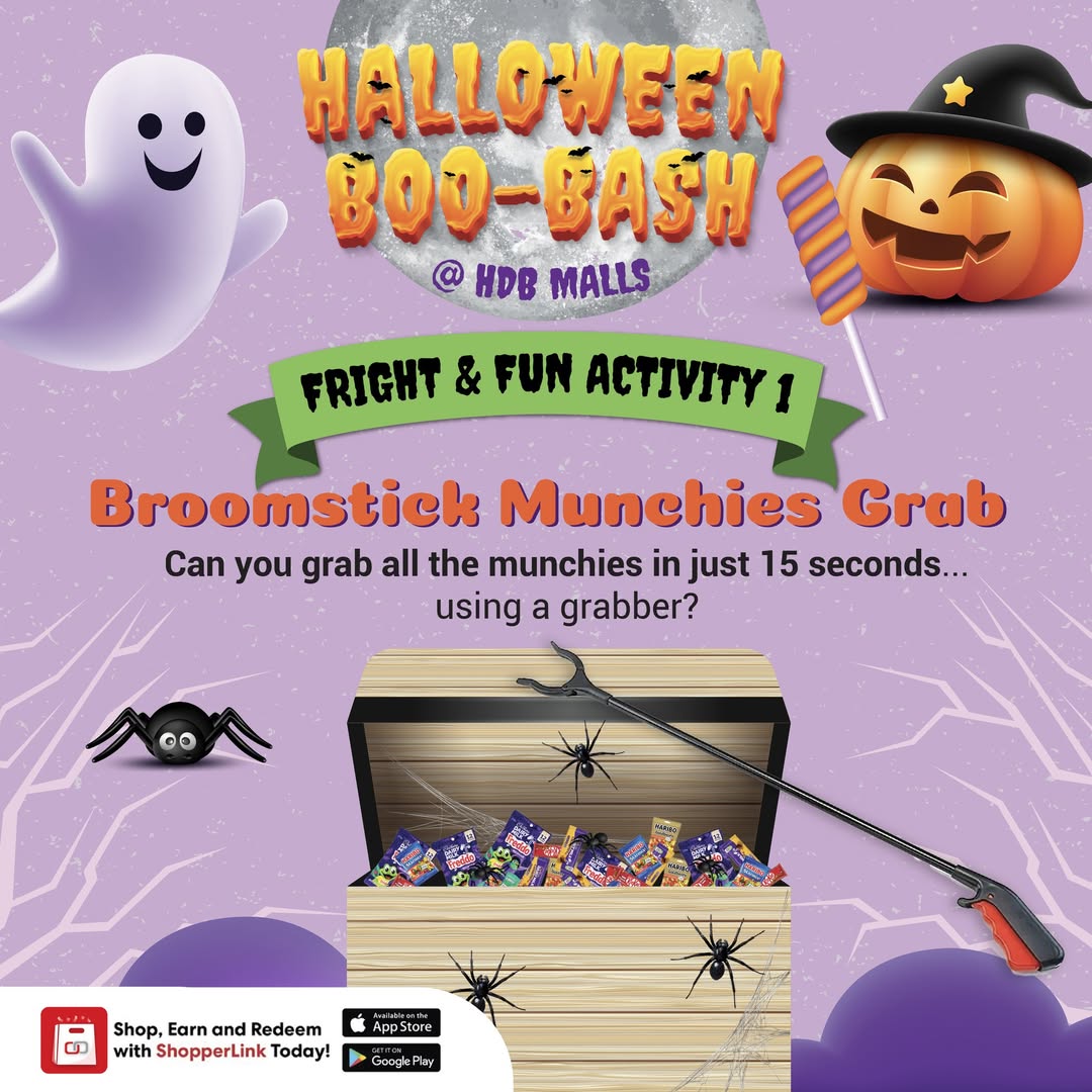 Children eagerly grabbing treats at a Halloween event with broomsticks.